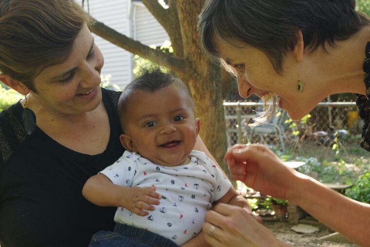 Katie (left, in black shirt) and Heather (right, purple shirt) with Oscar.