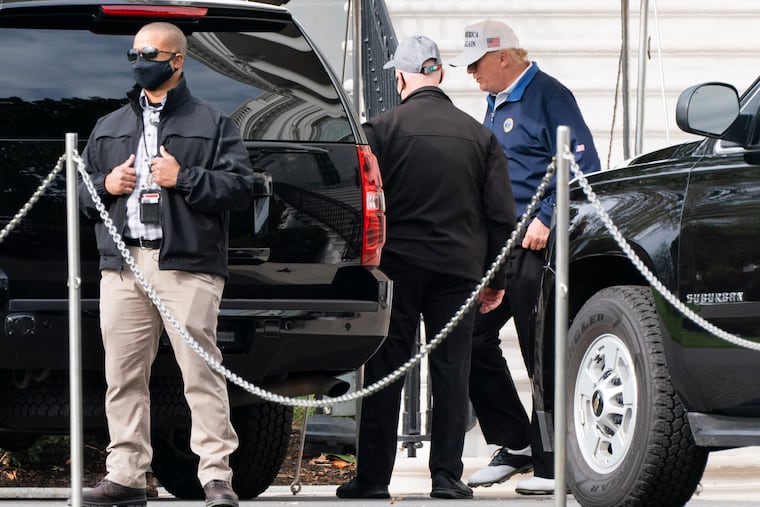 President Donald Trump, right, walks to the motorcade, Sunday, Nov. 22, 2020, as he departs the White House in Washington.