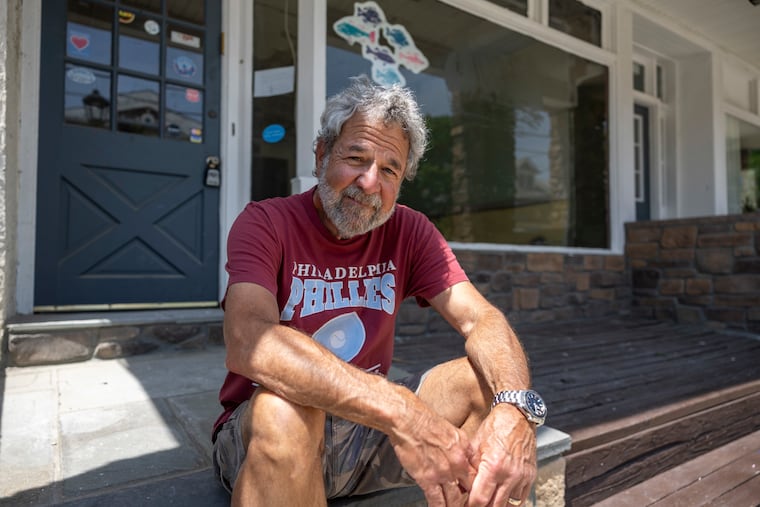 Dan Gold, recently retired owner of Danny’s Guitar Shop, poses outside his old shop in Narberth, Pa. Gold closed up shop at the end of May after 17 years of serving musicians on and around the Main Line.