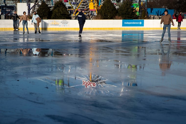 People ice skate on a warm day at the Blue Cross Riverrink Winterfest on the Delaware River Waterfront in Philadelphia, Pa. on Tuesday, December 14, 2021. It was the second warmest December on record.