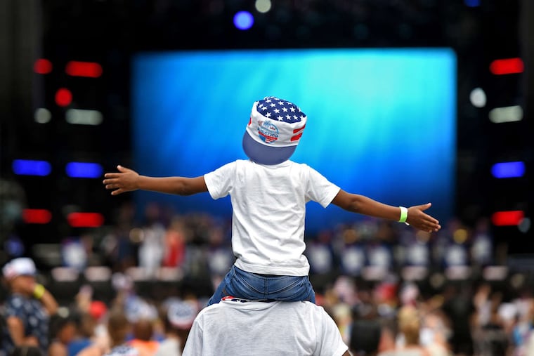 Five year-old Mahski sits on the shoulders of her aunt Shondell Anderson of West Philadelphia, as the Philly POPS Big Band takes the stage on Eakins Oval July 4, 2018 as the city hosts the free Party on the Parkway, part of the Wawa Welcome American Fourth of July festivities.