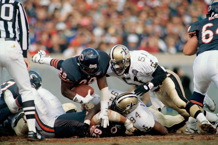 Saints Linebacker Sam Mills (51) comes in for the hit on the Chicago Bears' Raymont Harris (29) on Oct. 9, 1994, at Soldier Field in Chicago.