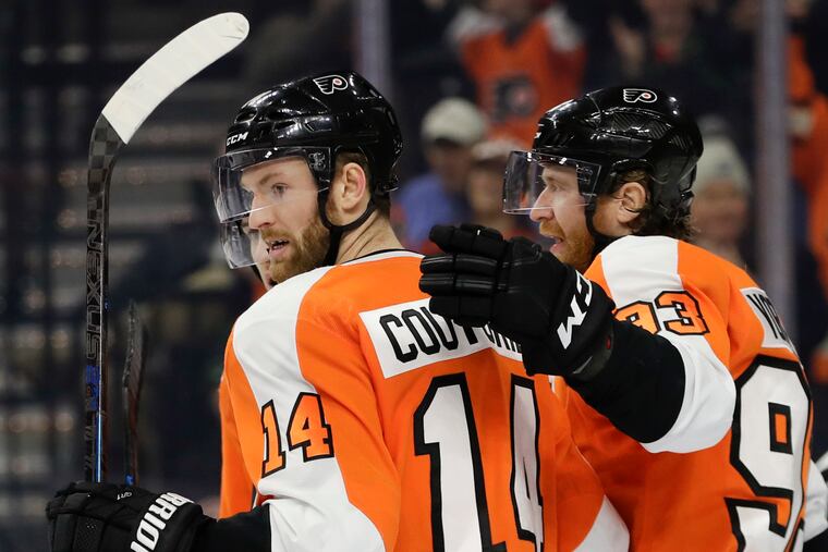 Flyers center Sean Couturier celebrates his second-period goal Monday with teammate Jake Voracek.