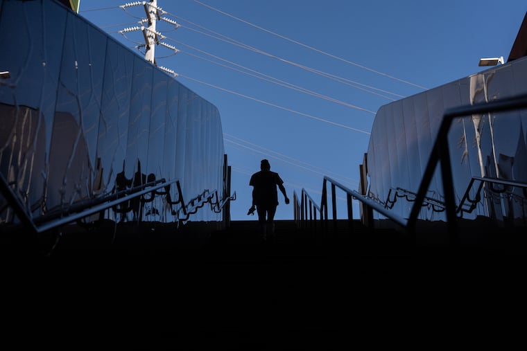 Quantavia Smith walks up the steps of a metro station next to the Santa Monica and Vermont Apartments, where she lives, in Los Angeles. It is time for Philadelphia's City Council to pass Bill 260517, which would expand the city's transit overlay and allow more housing near transit hubs, writes Jay Arzu.