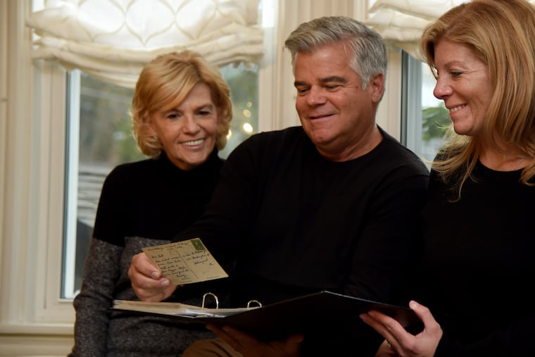 Alfonso Garbayo (center) talks with descendants of the late William G. Rohrer Jr. in Haddonfield recently. Garbayo, who collects vintage postcards, purchased 60 cards from the 1920s through '40s that once belonged to the prominent South Jersey businessman so he donated them to his family, including his daughter, Linda Rohrer (left) and his granddaughter, Stacey Vail (right). The cards were sent by family members, neighbors, friends -- and even customers of the Chevrolet dealership Rohrer owned on Admiral Wilson Boulevard in Camden for decades.