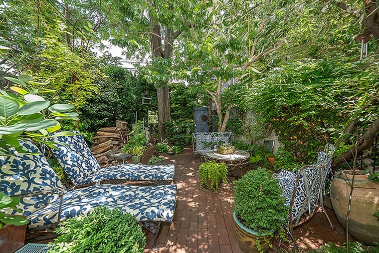 French doors in the kitchen open to a brick-paved garden with plantings, trees and waterfall in addition to a koi pond.