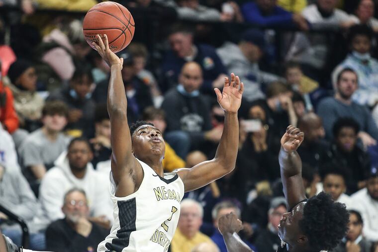 Neumann-Goretti's Rob Wright III tries to grab a pass over Archbishop Ryan's Michael Paris during the Catholic League championship game at the Palestra on Feb. 28, 2022.