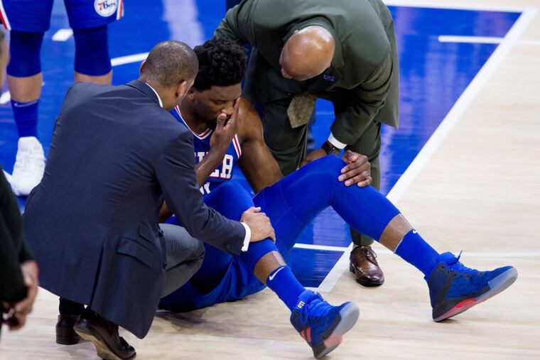 Philadelphia 76ers Center Joel Embiid suffers an injury during a game against the New York Knicks.