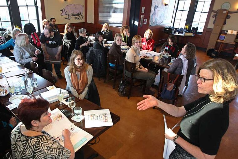 Inquirer food editor Maureen Fitzgerald (right) talks to the volunteers for My Daughter's Kitchen cooking classes. They gathered at Lo Spiedo at the Navy Yard to prep for this year's session of cooking classes. ( Michael Bryant / Staff Photographer )