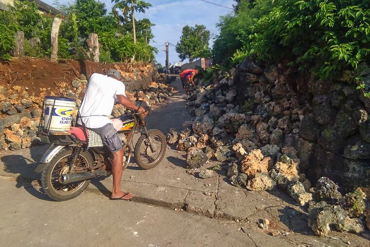 A resident looks at damages in Itbayat town, Batanes islands, northern Philippines following the earthquakes Saturday, July 27, 2019. Two strong earthquakes hours apart struck a group of sparsely populated islands in the Luzon Strait in the northern Philippines early Saturday.