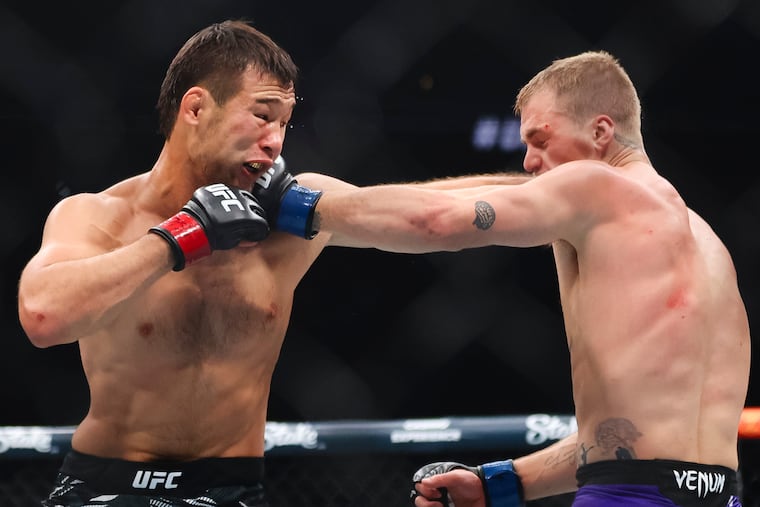 Ian Machado Garry (right) shown fighting Shavkat Rakhmonov at UFC 310 in 2024.