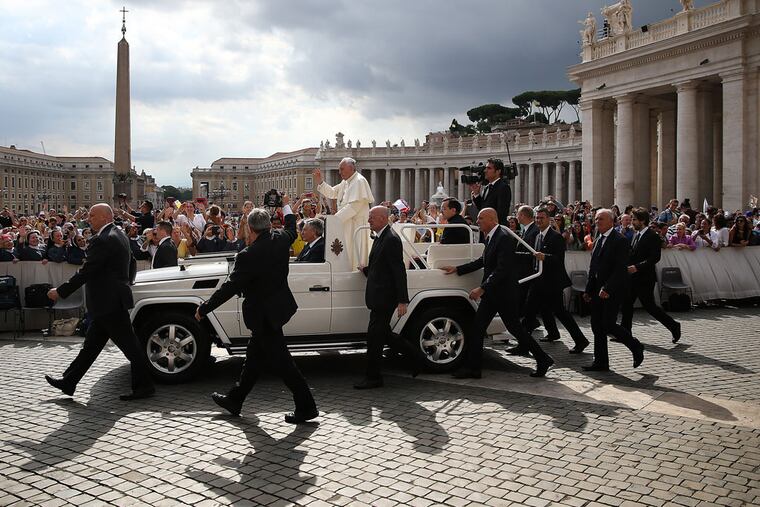 Pope Francis waves as he arrives in St Peter's Square at the Vatican for his weekly Papal Audience in Rome, Italy on June 24, 2015. (DAVID MAIALETTI / Staff Photographer)