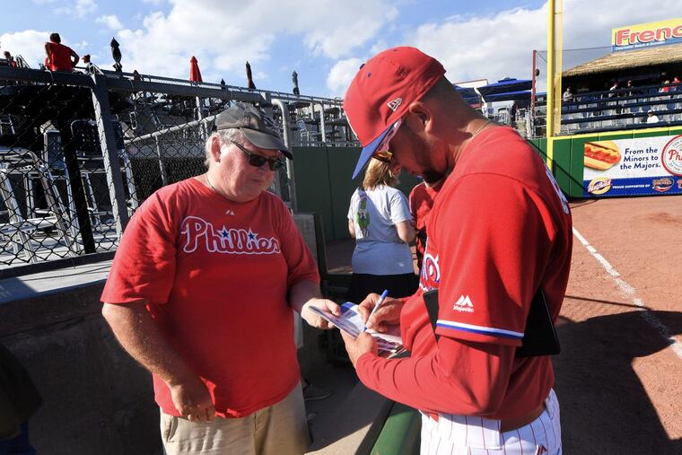 Phillies coach Pedro Guerrero signs autographs after the team’s exhibition game against the University of Tampa last week.