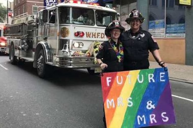 Woodbury Heights, NJ volunteer firefighters Molly Hubert (left) and her fiance Sydney Farrell marched in Philly's Pride parade June 10. The women both said nervousness gave way to exhilaration as crowds cheered them on through the streets of Center City.