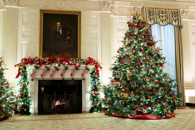 First Lady Jill Biden opted for a traditional Christmas look, with red-and-white-striped stockings hung in the East Room with the Biden grandchildren's names.