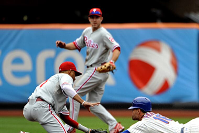 Mets' Angel Pagan is tagged out by Wilson Valdez while trying to steal second in the Phillies' 3-0 win. (AP Photo/Kathy Kmonicek)