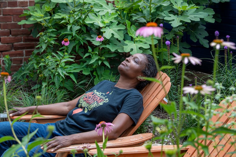 Gloria Page relaxes at the Brewerytown Garden on Wednesday, June 22, 2022, in Philadelphia. The garden is use in form of wellness post pandemic.