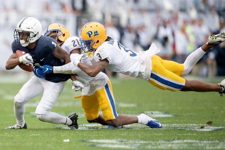 Pitt's Damarri Mathis and Damar Hamlin try to pull down Penn State wide receiver KJ Hamler.