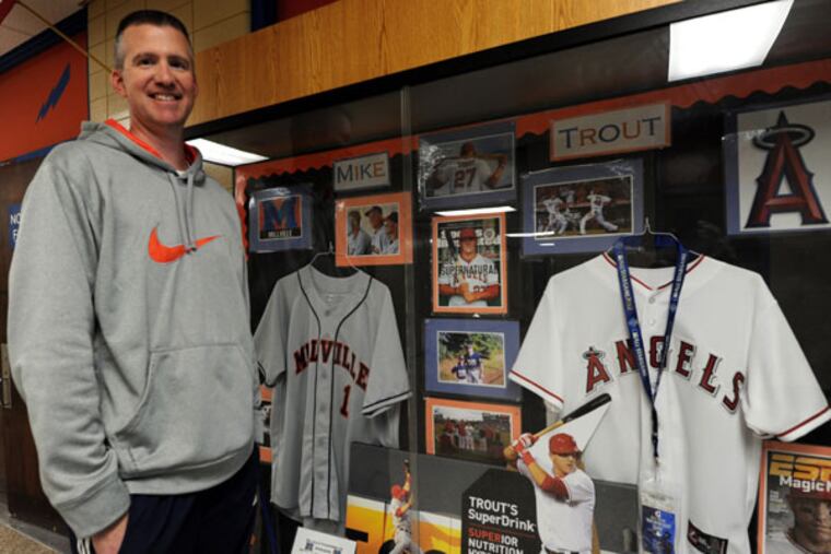 Mike Trout's high school coach Roy Hallenback in front of a showcase of Trout's memorabilia. (April Saul/Staff Photographer)