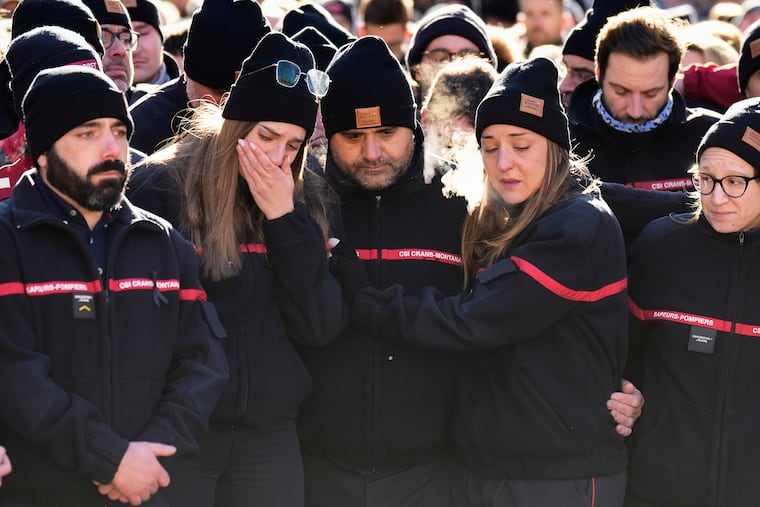 Firefighters cry as they attend a memorial march in Crans-Montana, Swiss Alps, Switzerland, Sunday, Jan. 4, 2026, after a devastating fire in Le Constellation bar left dead and injured during the New Year's celebrations.