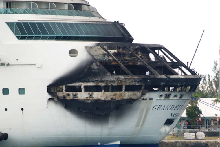 The stern of Royal Caribbean's Grandeur of the Seas shows extensive fire damage at the dock in Freeport, Bahamas. (JENNEVA RUSSELL / Freeport News)