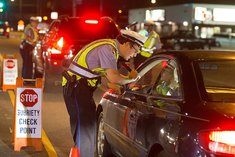 Philadelphia police last month set up a late-night sobriety check on Aramingo Avenue, stopping all motorists. ED HILLE / Staff Photographer