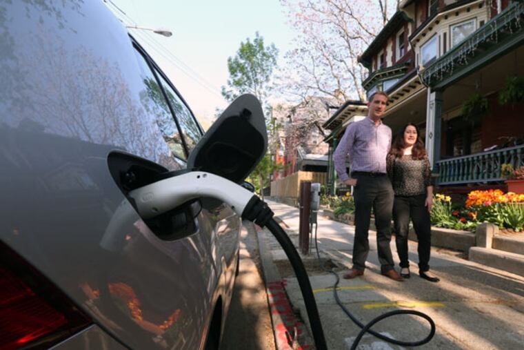 Jaap Veneman and his wife, Sarah Shackley, top, who recently installed a curbside charger for their Volkswagen e-Golf. The cost is upward of $4,000, including PPA permits. But soon, the parking is all theirs. ( DAVID SWANSON / Staff Photographer )