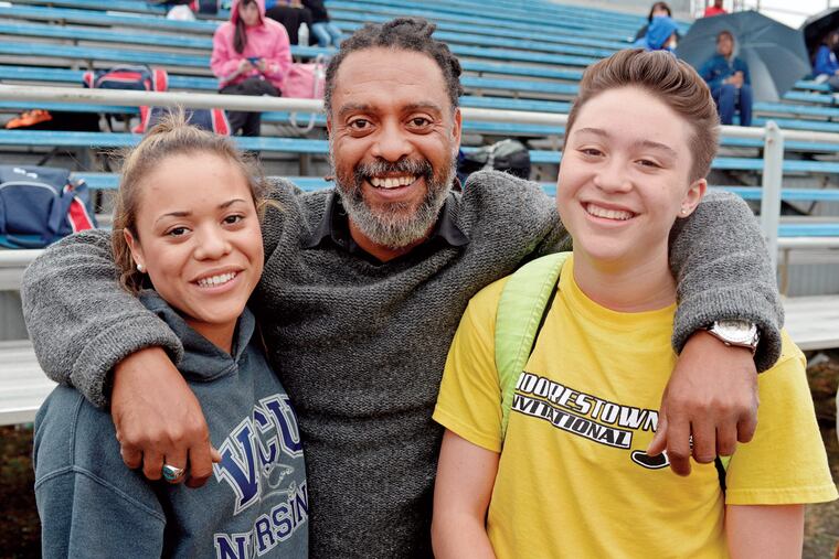 Matt Dawkins (right) hangs out with twin sister Jada Dawkins and their father, Nigel Dawkins, during a meet at Washington Township High School on April 14, 2015.