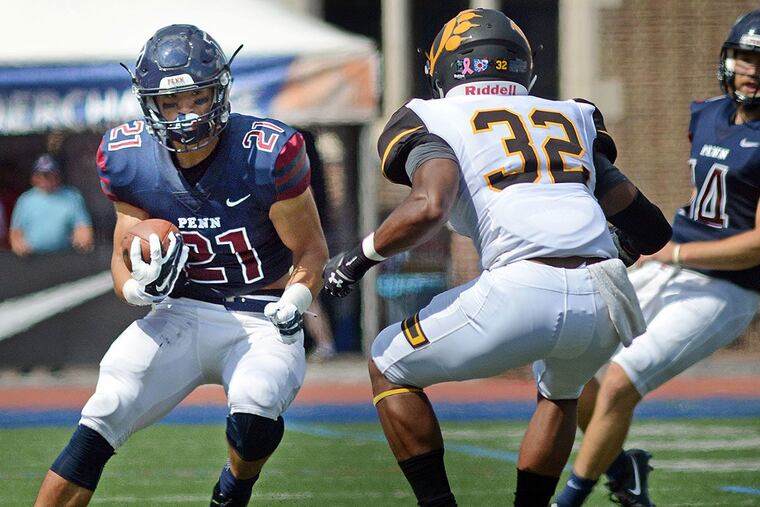 Penn’s Abe Willows (21) runs with the football as Ohio Dominican’s Tyren Jackson (32) defends.