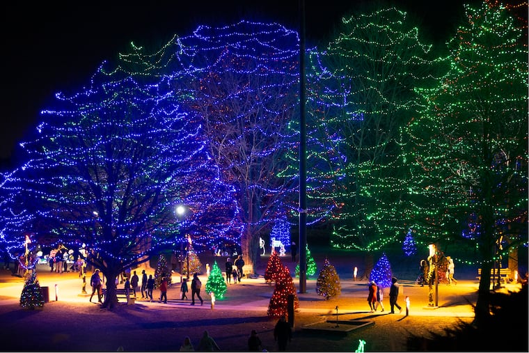 People walk through the Festival of Lights at Rose Tree Park in Delaware County on Dec. 22, 2021.