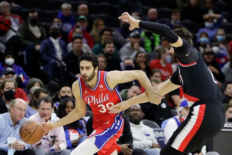 Sixers guard Furkan Korkmaz dribbles the basketball against Portland Trail Blazers center Jusuf Nurkic on Monday, November 1, 2021 in Philadelphia.