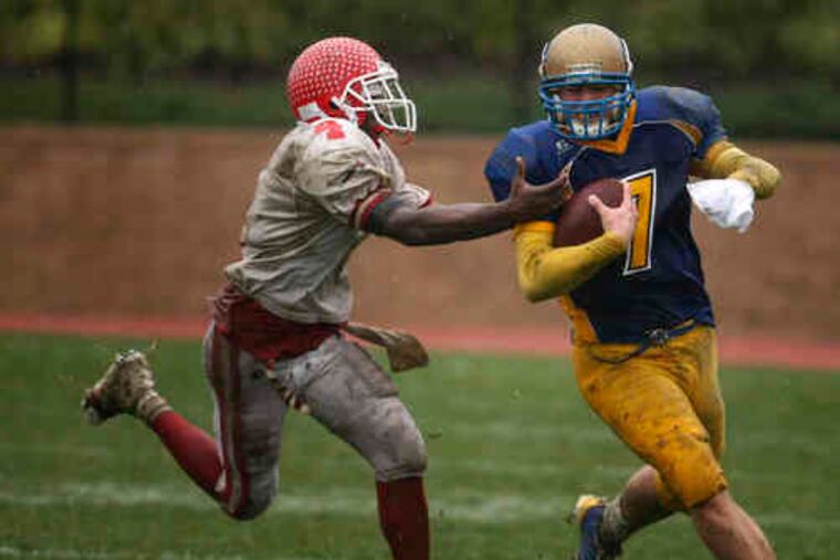 Woodbury's Brian Purnell shakes an arm tackle by Aaron Tilden to score a touchdown in the Herd's 16-0 victory.
