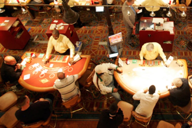 Gamblers sit at tables at the Tropicana Casino in Atlantic City. (David Swanson / Staff Photographer)