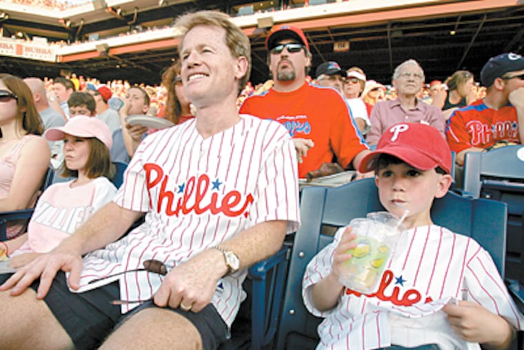 Todd Rodzik sits with daughter Caitlin and son Alden at a Phillies game last week with tickets purchased at StubHub. (Barbara L. Johnston / Inquirer)