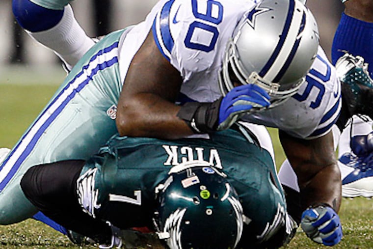 Eagles' Michael Vick gets taken down against Dallas Cowboys' Jay Ratliff. (Yong Kim/Staff Photographer)