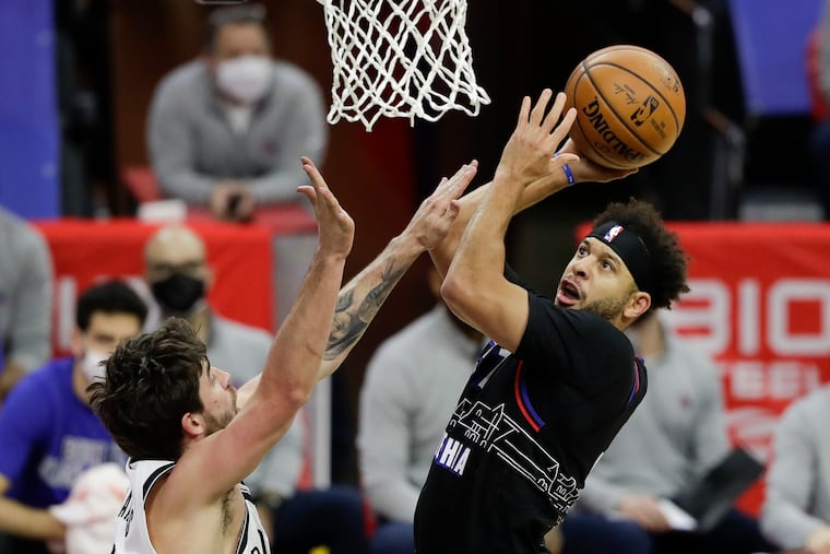 Sixers guard Seth Curry shoots the basketball against Brooklyn Nets forward Joe Harris on Saturday, February 6, 2021 in Philadelphia.
