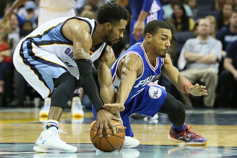 Philadelphia 76ers guard Phil Pressey (26) dives for a loose ball against Memphis Grizzlies guard Mike Conley (11) at FedExForum. Memphis defeated Phiadelphia 92-84.
