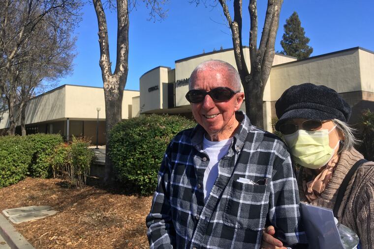 Eugenia Kendall, right, wears a mask outside of the Vacaville City Hall while standing with her husband, Ivan, Thursday, Feb. 27, 2020, in Vacaville, Calif.