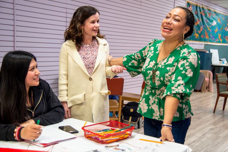 Maureen Boland (center), Claudia Peregrina (right), director of programs at Mighty Writers, and student Nalleli Flores Garcia, 14. Boland is leaving a teaching post at Parkway Center City Middle College to join Mighty Writers and begin a citywide conversation about some of the most pressing issues in Philadelphia with a podcast and writing workshops.