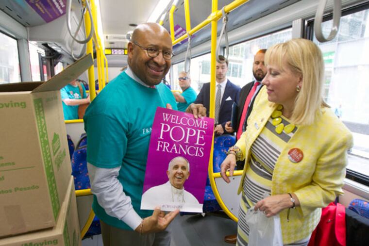 Mayor Michael Nutter, left, and Donna Crilley Farrell, executive director of the World Meeting of Families, show the poster from an "OpeninPHL" kit. (CHARLES FOX/Staff Photographer)