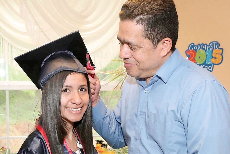 Ramon Melo (Dad) is proud of his daughter, Esperliss Melo, who graduated from Atlantic Cape Community College (Tom Briglia/ For the Inquirer)