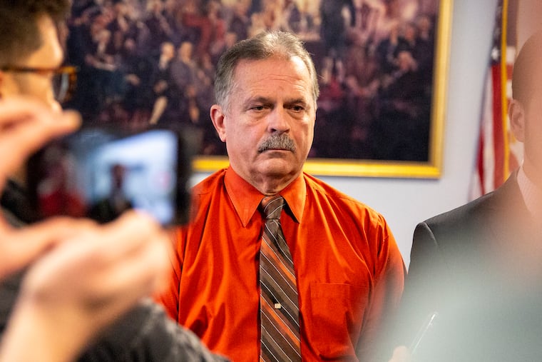 Bordentown Township Police Chief Frank Nucera Jr., stands in silence as Defense Attorney Rocco Cipparone speaks to the press answering questions on the mistrial in federal court in Camden.