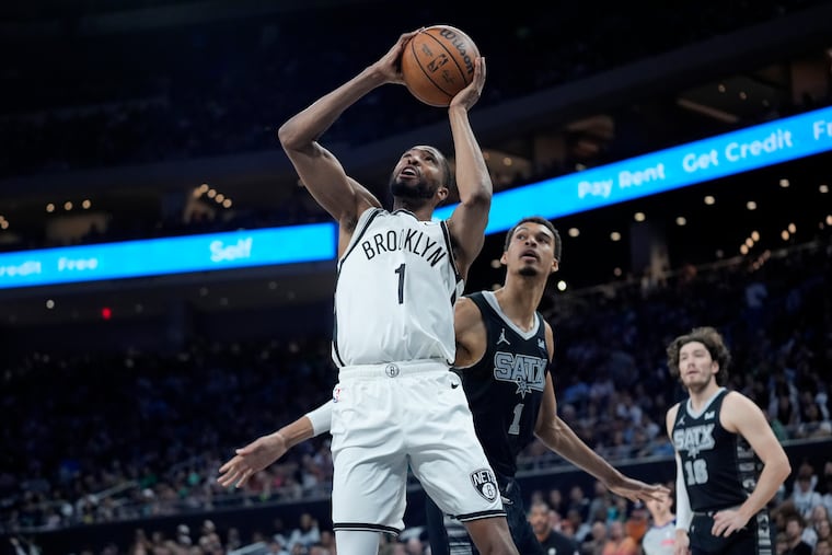 Mikal Bridges (left) will be traded to the Knicks.