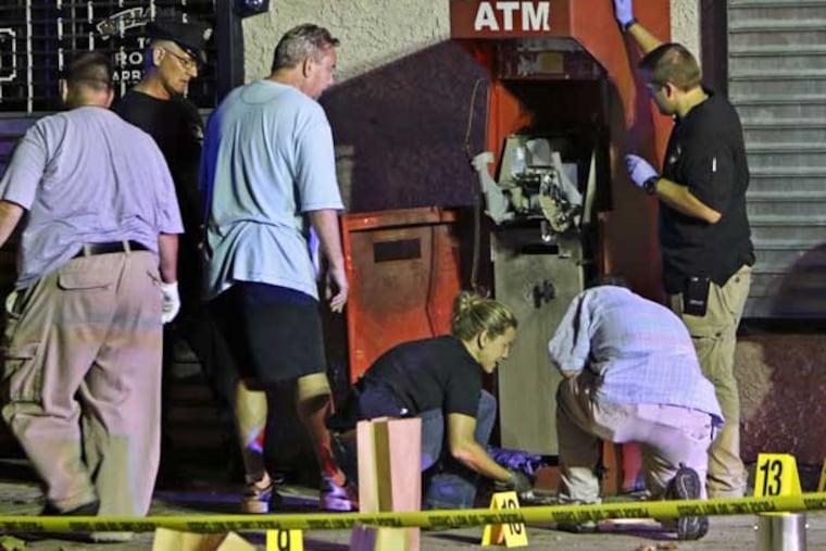 Police investigate an ATM explosion in Hunting Park on July 21, 2015. (Joseph Kaczmarek/For The Inquirer)