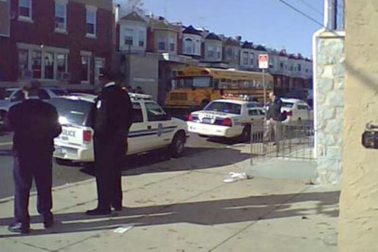 A teenager shot and wounded another youth on a school bus taking students to a disciplinary high school this morning, police said. The gunfire erupted in the back of this bus around 8 a.m. on Pine Street, near 57th Street, in West Philadelphia. (Peter Mucha / Staff)