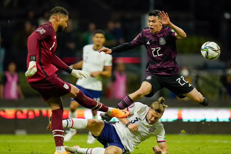 United States' goalkeeper Zack Steffen, left, clears the ball as Mexico's Hirving Lozano (22) jumps over United States' Walker Zimmerman during a qualifying soccer match for the FIFA World Cup Qatar 2022 at Azteca stadium in Mexico City, Thursday, March 24, 2022. (AP Photo/Eduardo Verdugo)