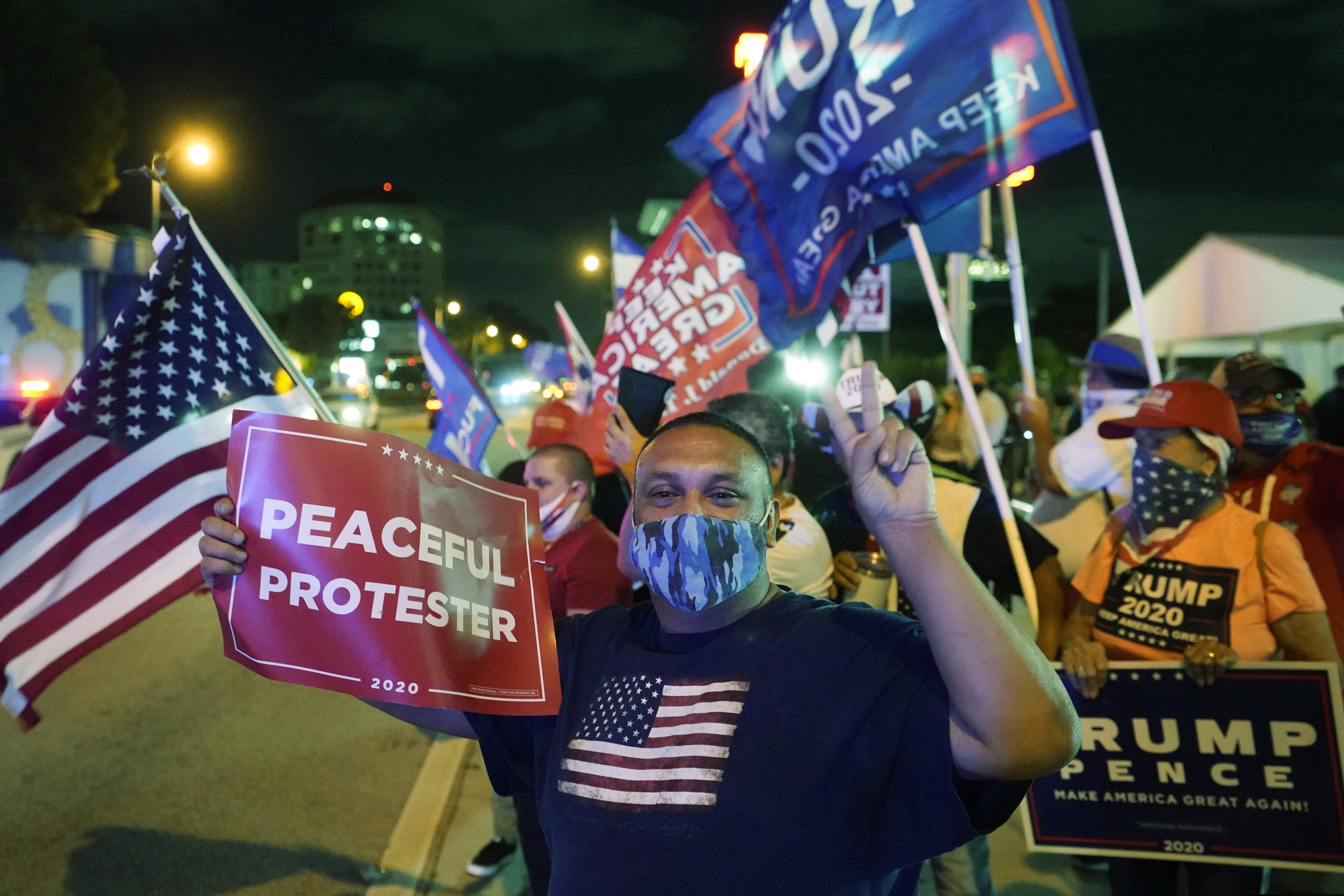 Supporters of President Donald Trump chant and wave flags outside the Versailles Cuban restaurant during an Election Night celebration, Tuesday, Nov. 3, 2020, in the Little Havana neighborhood of Miami. Trump and his Republican allies made significant inroads with Latino voters in Tuesday’s election, alarming some Democrats who warned that immigration politics alone was not enough to hold their edge with the nation’s largest minority group.
