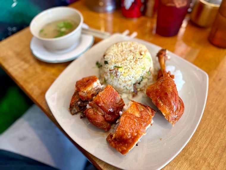 Vietnamese fried chicken, Cơm Gà Xối Mỡ, is served at Pho Duyen in South Philadelphia with fried rice, pickled Daikon cubes, and a cup of broth.