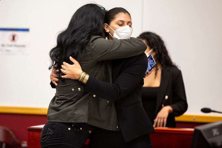 Des Moines Register Reporter Andrea Sahouri hugs her mom Muna Tareh-Sahouri after being found not guilty at the conclusion of her trial.