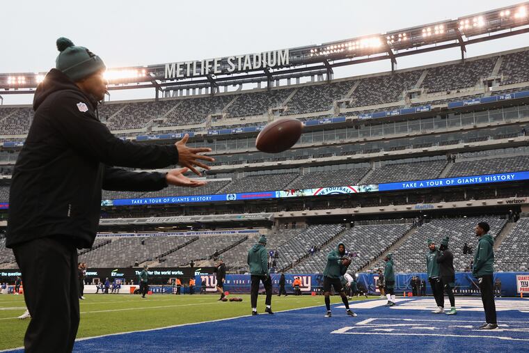 Eagles players warm up before a game against the New York Giants at MetLife Stadium in East Rutherford, N.J.